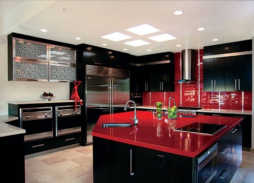 Red kitchen design with black cabinets and red countertops in home kitchen.