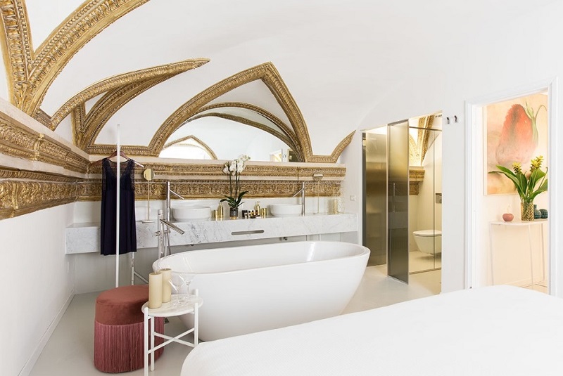 Amazing white bathroom with bathtub installed in Costaguti experience palace in Rome, Italy